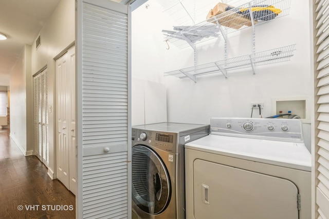 clothes washing area featuring dark hardwood / wood-style flooring and washing machine and clothes dryer