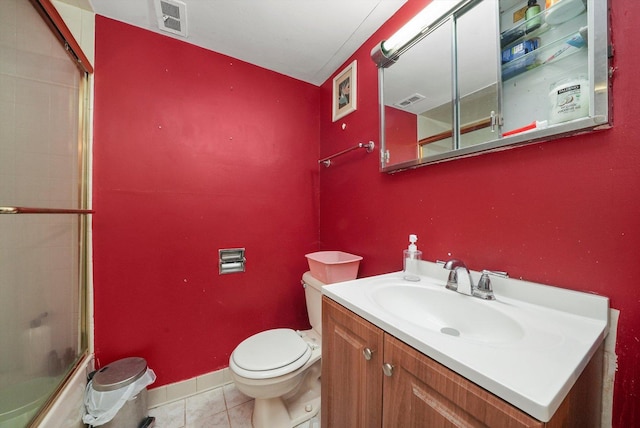 bathroom featuring tile patterned flooring, vanity, and toilet