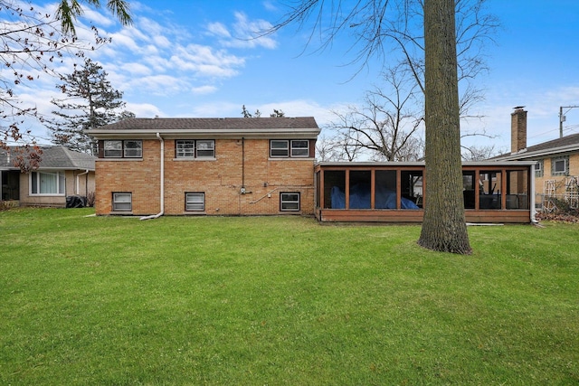 back of house featuring a sunroom and a yard