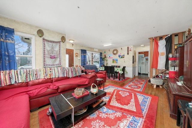 living room with plenty of natural light and hardwood / wood-style flooring