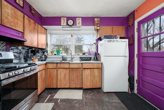 kitchen with ventilation hood, sink, gas range, decorative backsplash, and white fridge