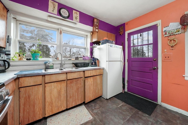 kitchen with white fridge, a healthy amount of sunlight, and sink