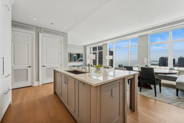 bedroom featuring a water view, ornamental molding, and light hardwood / wood-style flooring