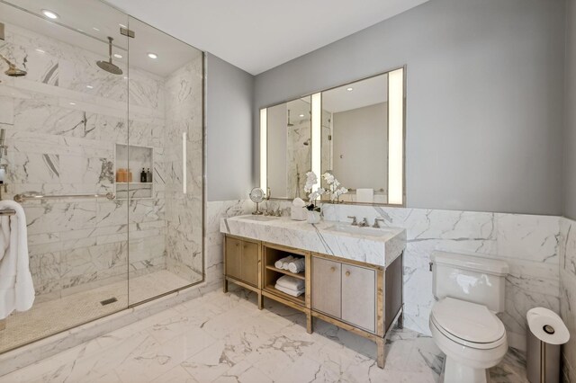 bathroom featuring vanity, a relaxing tiled tub, tile walls, and toilet