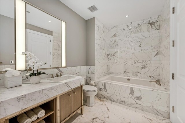 bathroom featuring tile walls, vanity, and toilet