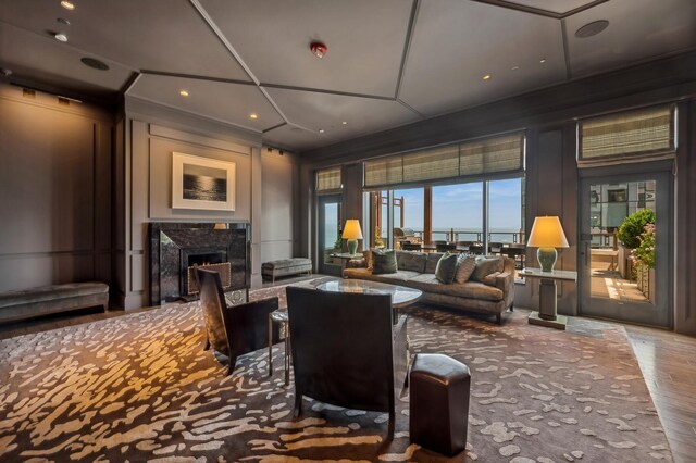 exercise room featuring coffered ceiling and a high ceiling