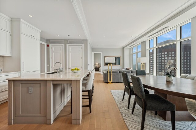 living room with ornamental molding and light wood-type flooring