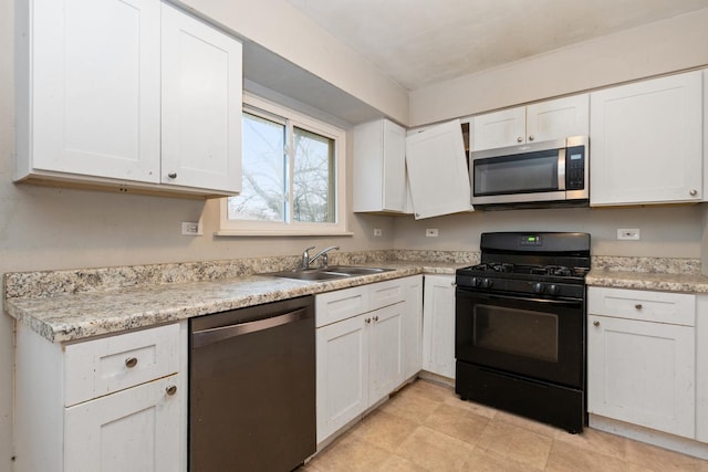 kitchen with white cabinets, stainless steel appliances, and sink