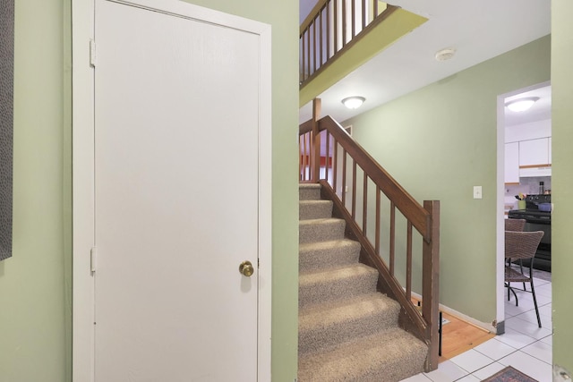 stairway featuring tile patterned flooring