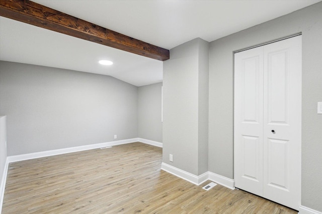 basement with light hardwood / wood-style flooring