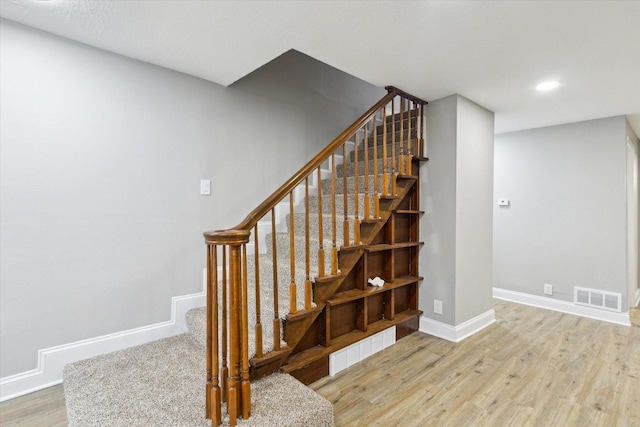 staircase with wood-type flooring