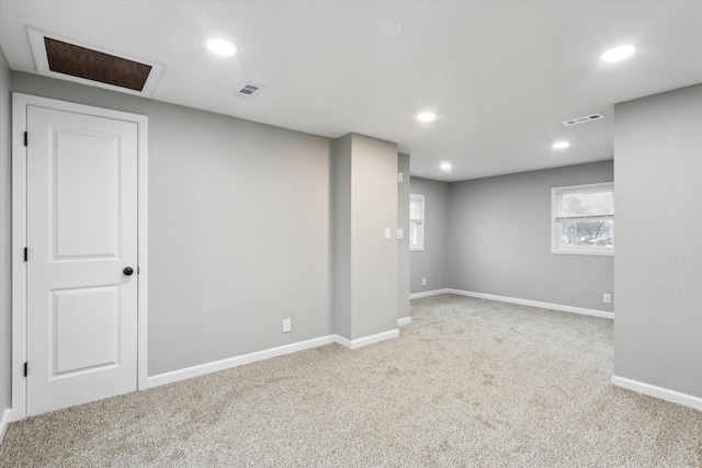 basement featuring light colored carpet