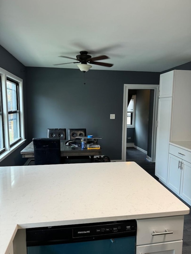 kitchen with dark hardwood / wood-style flooring, ceiling fan, dishwasher, and white cabinets