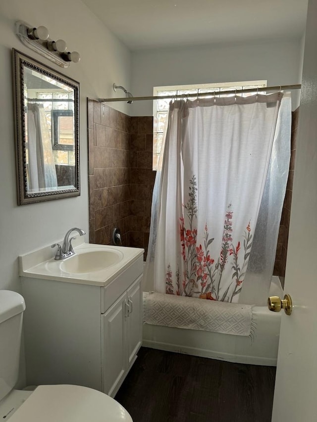 full bathroom with toilet, vanity, hardwood / wood-style flooring, and shower / tub combo with curtain