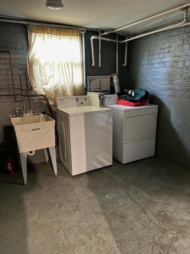 washroom featuring washer and clothes dryer and sink