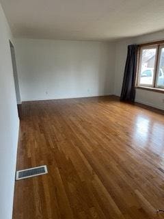 empty room with wood-type flooring