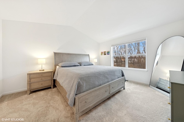 carpeted bedroom featuring lofted ceiling