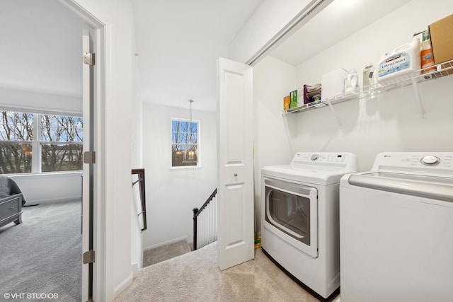 laundry area with light carpet and washing machine and dryer