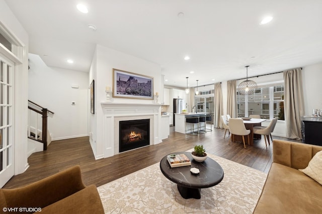 living room with a chandelier and dark hardwood / wood-style flooring