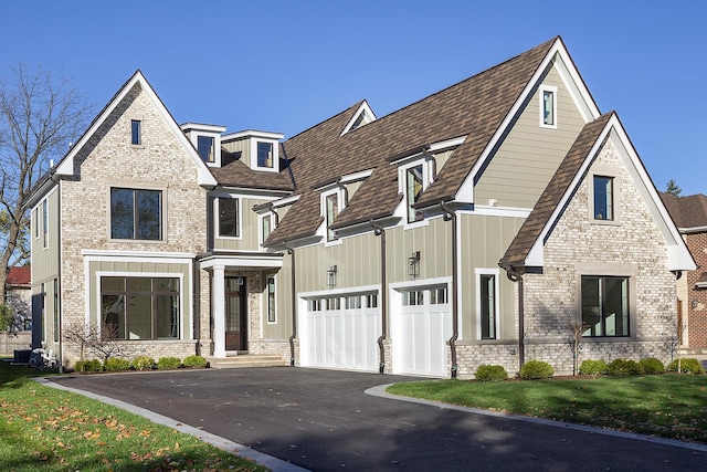 view of front of property featuring a garage, a front yard, and central AC