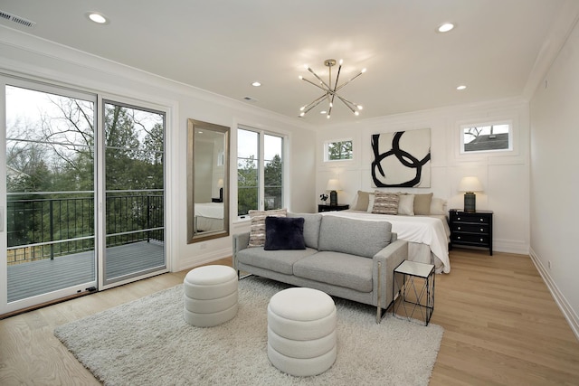 bedroom with access to exterior, light wood-type flooring, an inviting chandelier, and crown molding