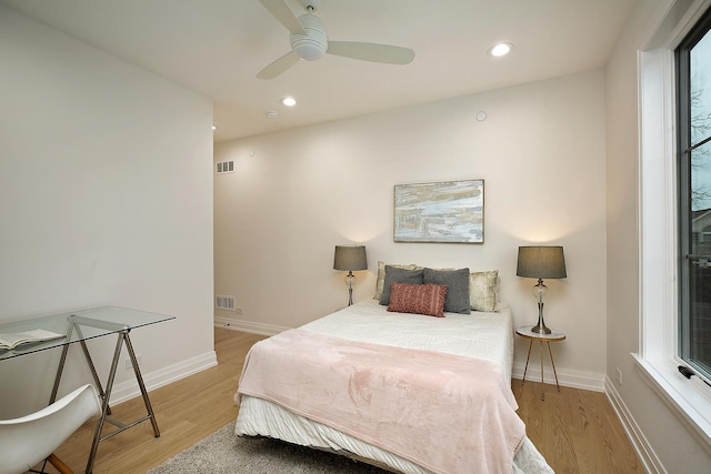 bedroom with light hardwood / wood-style flooring and ceiling fan