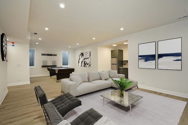 living room with light hardwood / wood-style floors and pool table