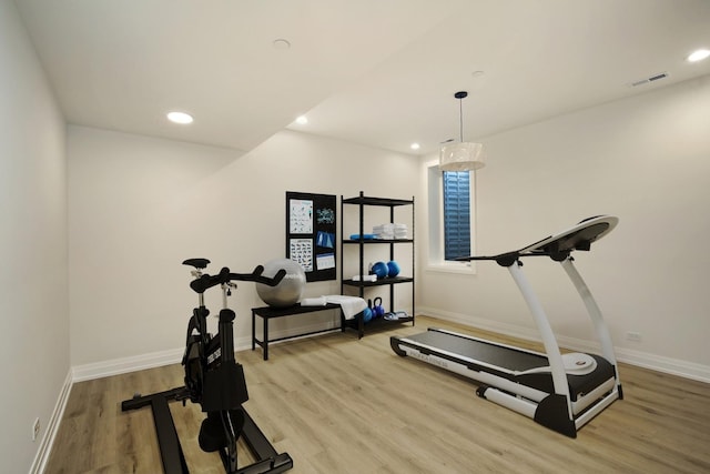 workout room with light hardwood / wood-style flooring