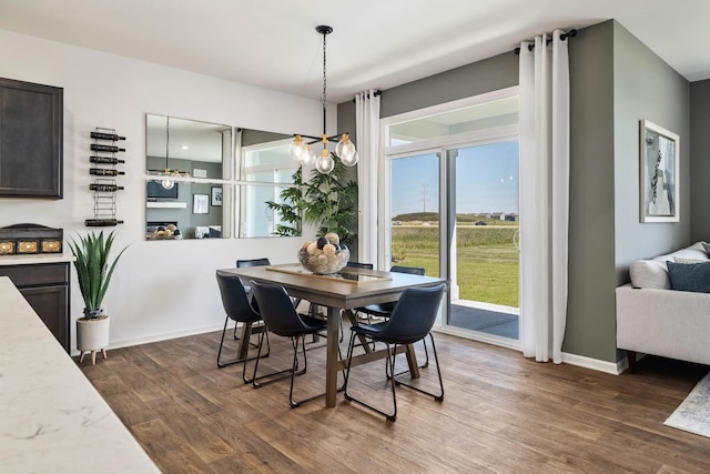 dining room featuring dark hardwood / wood-style flooring and a notable chandelier