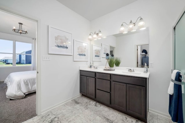 bathroom featuring a notable chandelier and vanity