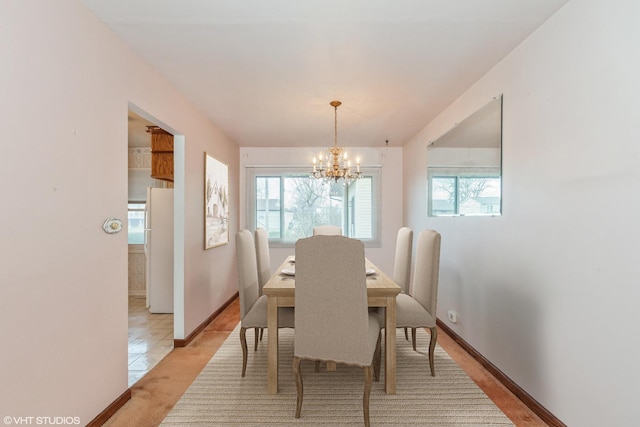 tiled dining area with an inviting chandelier