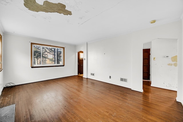 spare room with dark hardwood / wood-style floors and crown molding