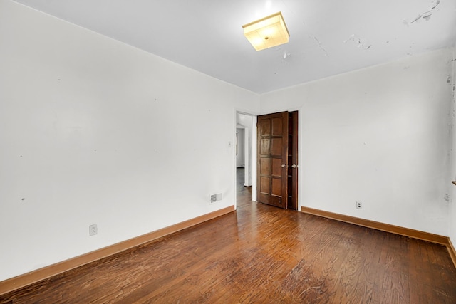 spare room with wood-type flooring