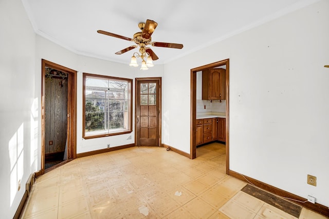 empty room featuring crown molding and ceiling fan