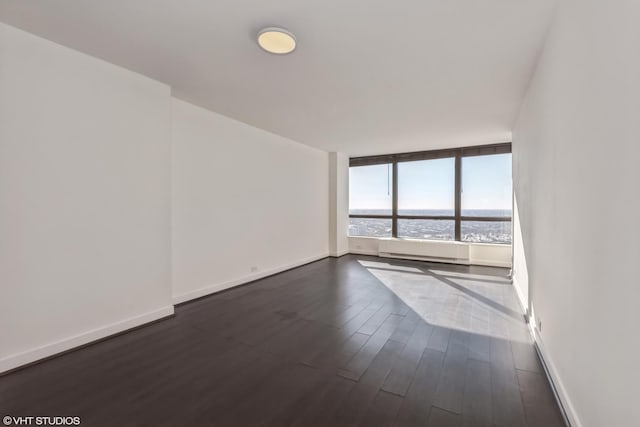 empty room with a water view and dark wood-type flooring