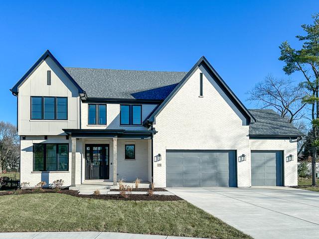 view of front of property with a garage and a front lawn