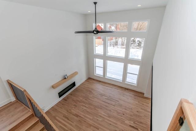 unfurnished dining area featuring ceiling fan and hardwood / wood-style flooring