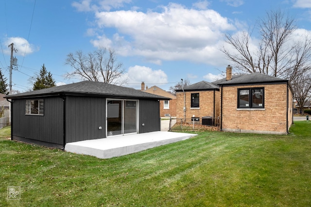 back of house with a patio area and a yard