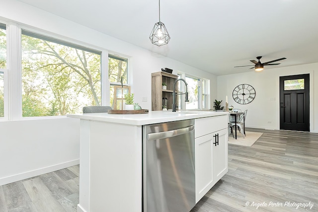 kitchen with dishwasher, a center island, white cabinetry, and plenty of natural light