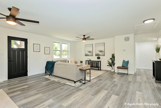 living room with ceiling fan and light hardwood / wood-style floors