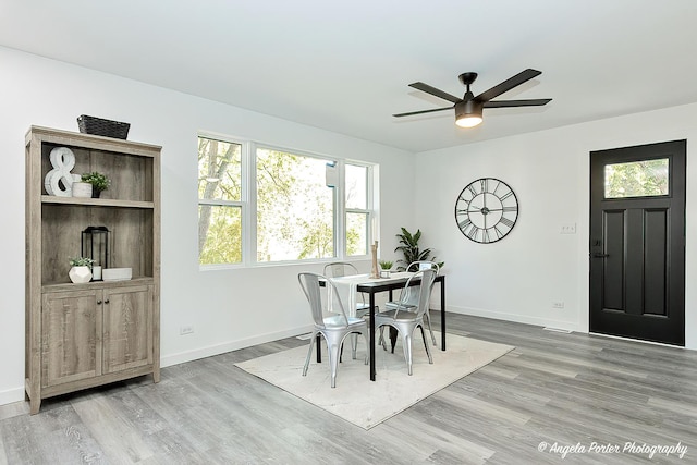 dining area featuring ceiling fan and light wood-type flooring