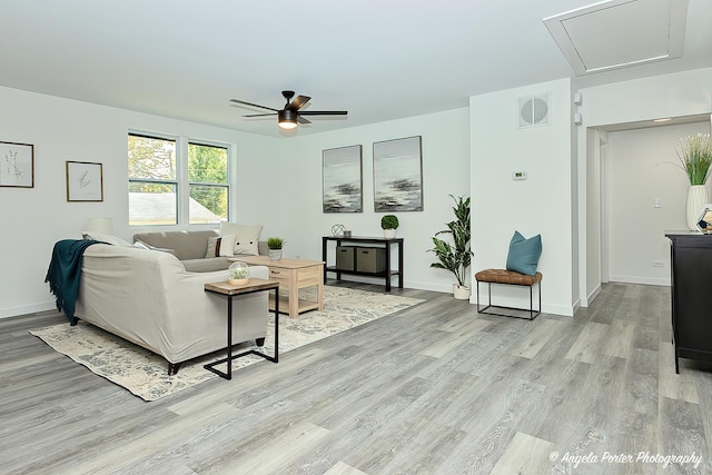 living room featuring ceiling fan and light wood-type flooring