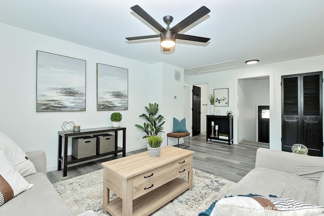 living room featuring ceiling fan and light wood-type flooring