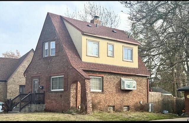 3231 N Schultz Dr, Lansing, IL 60438 - rear view of house featuring a shingled roof, brick siding, a chimney, and fence
