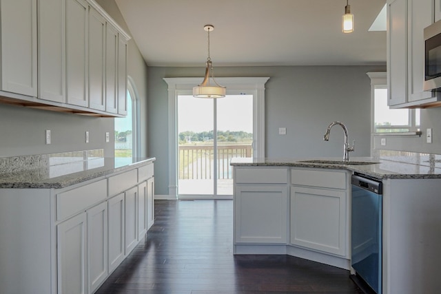 kitchen with dark wood-style floors, white cabinetry, a sink, and dishwashing machine