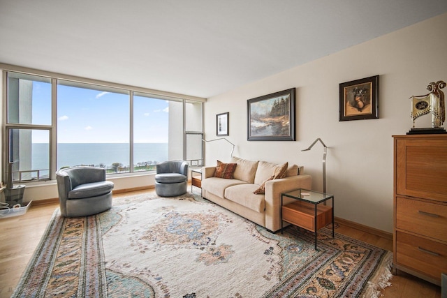 living room featuring wood-type flooring and a water view