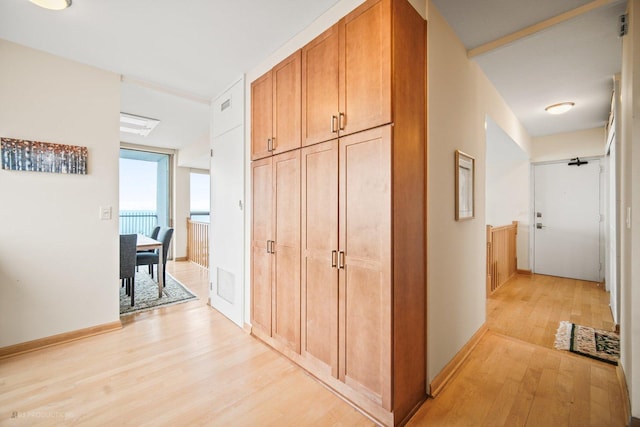 hallway with light hardwood / wood-style flooring