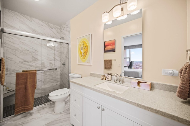 bathroom with vanity, toilet, and a shower with shower door