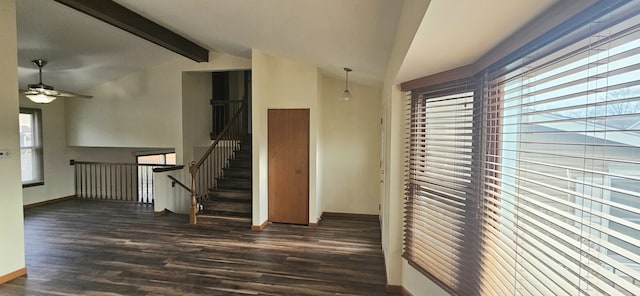 hall with vaulted ceiling with beams, plenty of natural light, and dark hardwood / wood-style floors