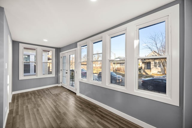 unfurnished sunroom featuring a wealth of natural light and french doors